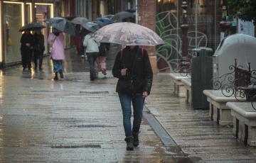 Varias personas se protegen de la lluvia bajo sus paraguas