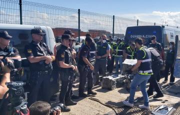 La mercancia incautada bajo la vigilancia de los agentes en las instalaciones del muelle donde fueron despositadas