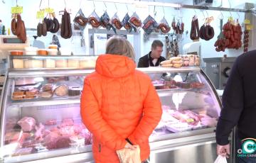 Clientes comprando en uno de los puestos del mercado. 