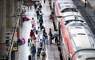 Varias personas esperan un AVE en la estación de Atocha-Almudena Grandes en una imagen de archivo.