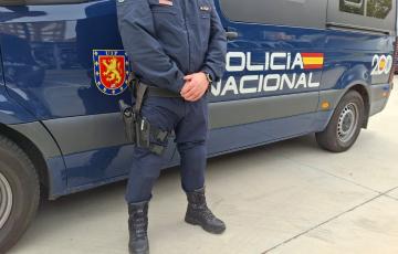 Imagen de archivo de un coche y un agente de la Policía Nacional