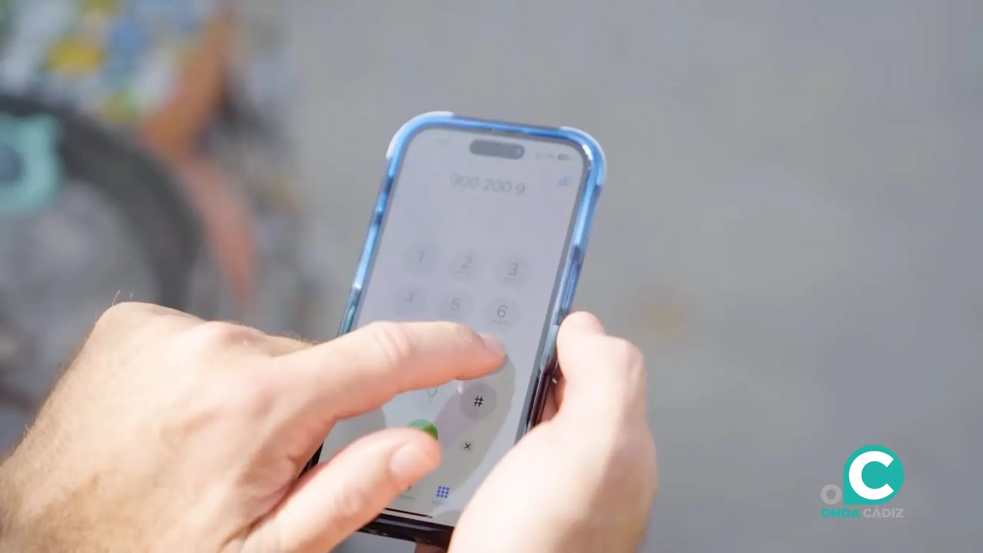 Una persona agenda en su dispositivo móvil el número de teléfono andaluz de atención a las mujeres. 